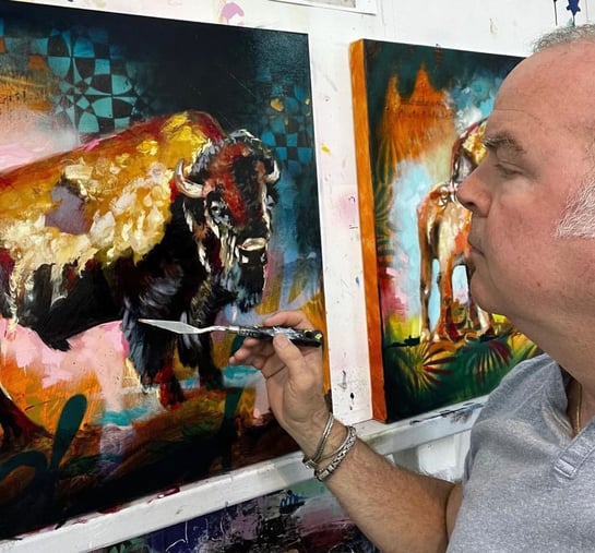 John Milan painting with a palette knife