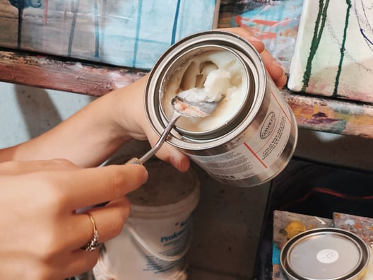 hand scooping Cold wax for art out of jar with pallet knife
