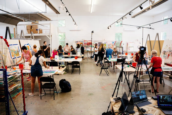 students painting on tables and easels 