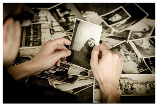 man holding black and white photos, Photo caption: Finding the right visual references for your paintings is critical if you want good art compositions. Image by Michal Jarmoluk from Pixabay