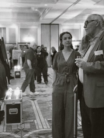 girl standing with man in gallery in black and white photo