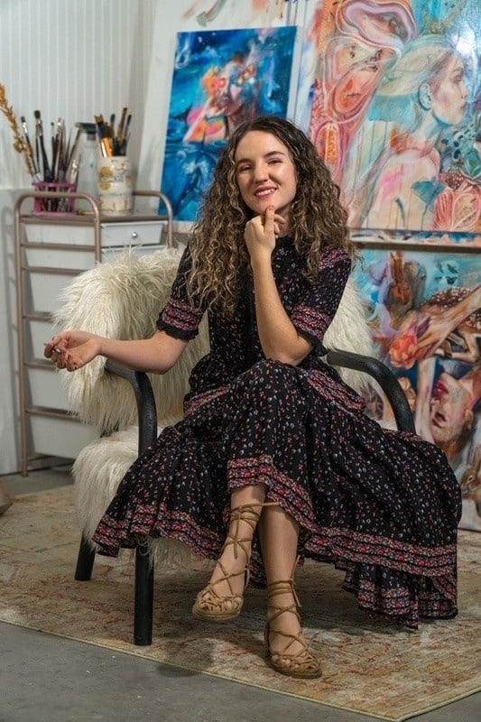 Dimitra Milan in front of her art