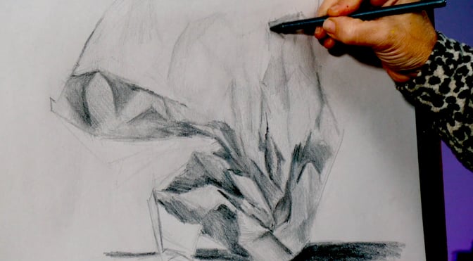 hand drawing a piece of paper on board