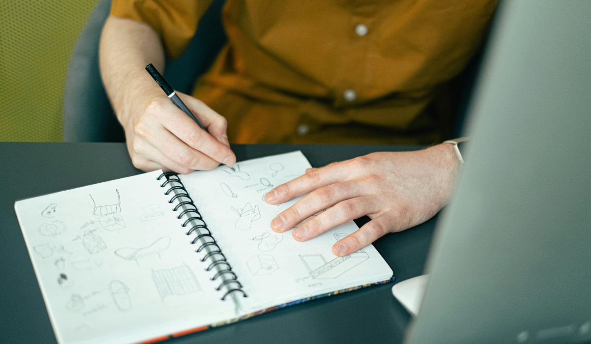 Person sketching in notebook