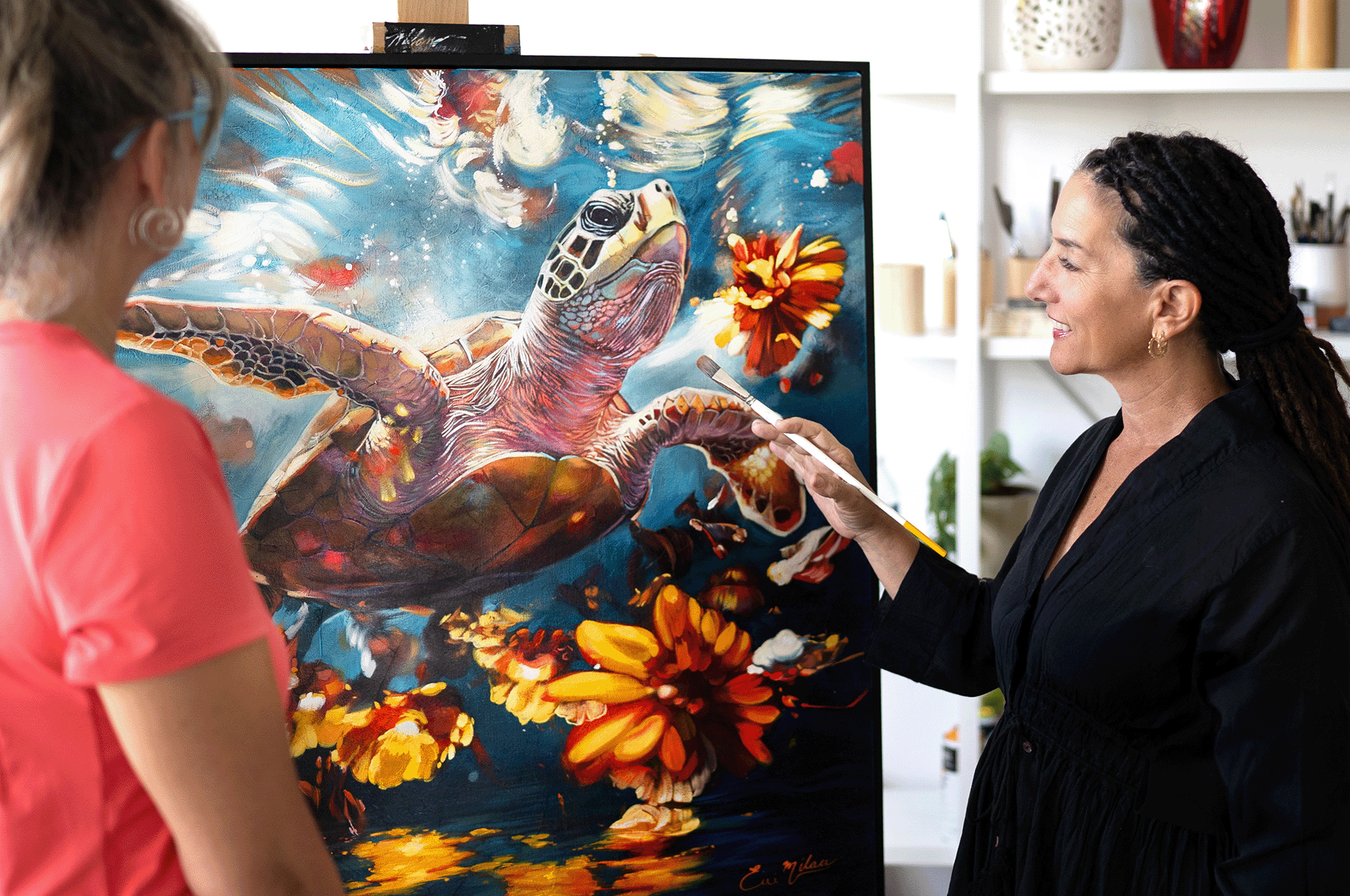 woman standing in fron of tutle painitng bluw water and yellow flowers