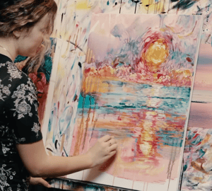 Women painting on paper Monet style painting  yellow green pink