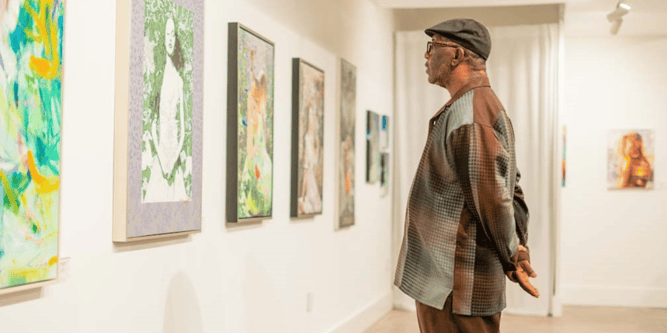 Man standing in front of art at Milan Art Institute Gallery