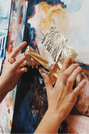 Hands working with Metal Leaf Floral painting 